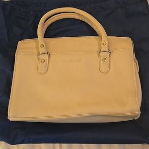 Medallion cream colored satchel with shoulder strap
